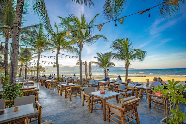 Beachfront restaurant with palm trees beside the ocean in Da Nang