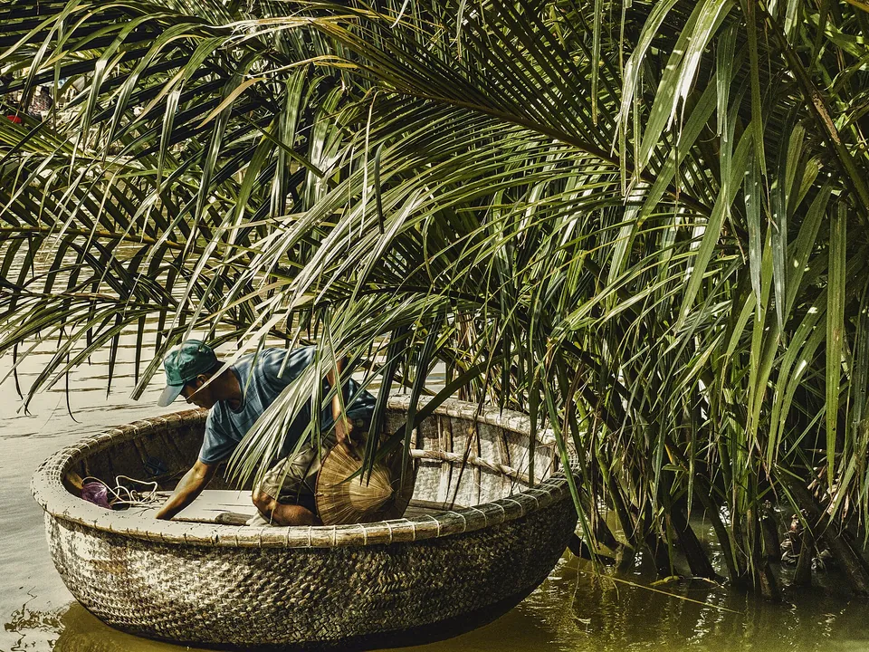 Round basket boat among water coconut palms