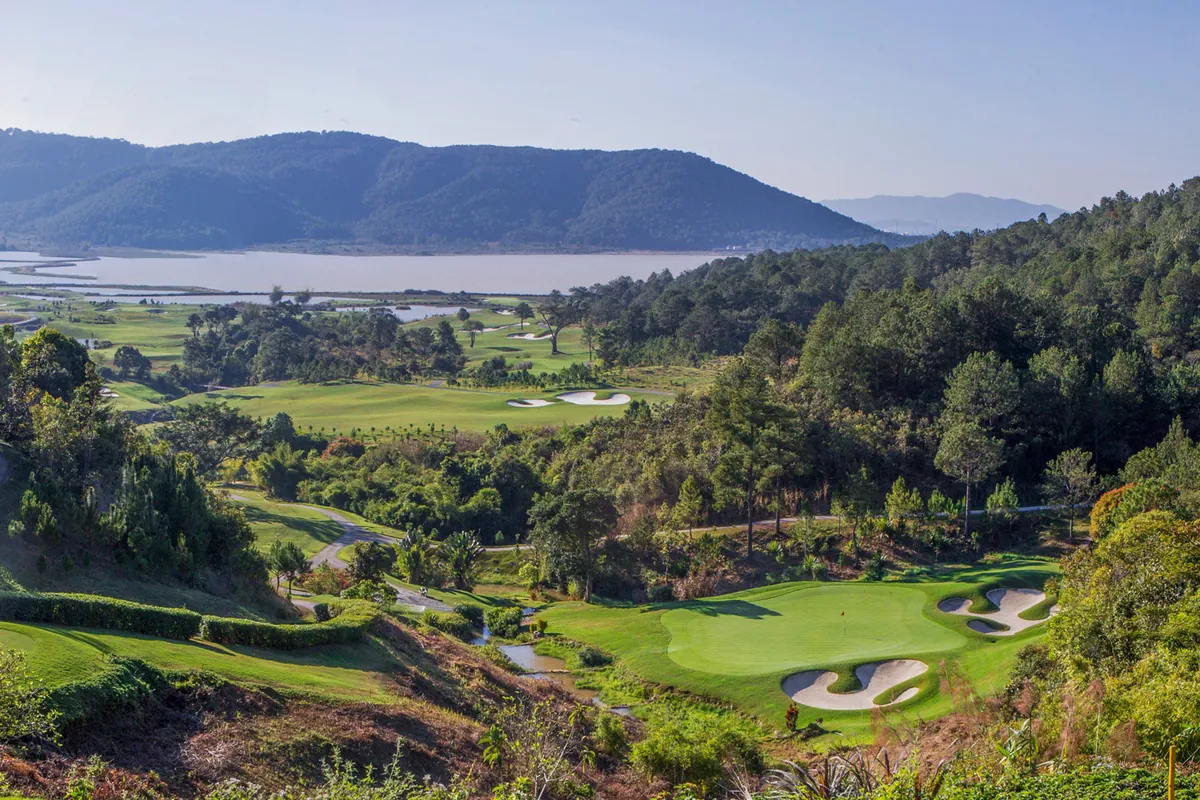 Greens and pine-covered hills above the lake at The Dalat at 1200