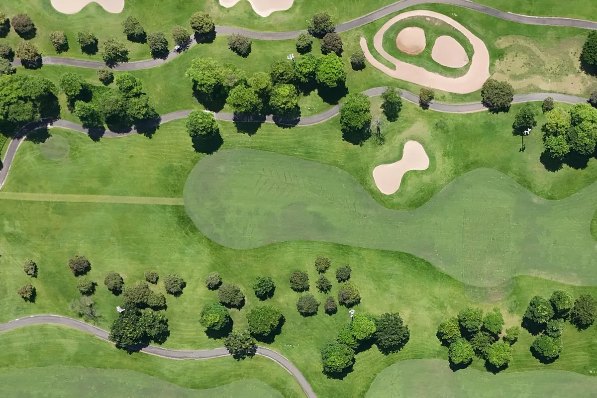 Aerial view of bunkers and tree-lined fairways at Twin Doves Golf Club