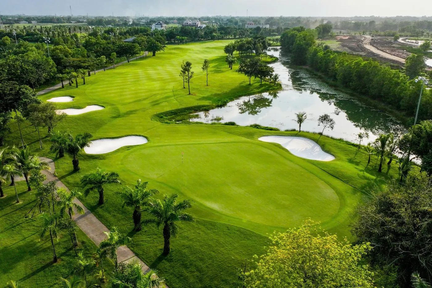 Aerial view of fairways and lake at West Lakes Golf