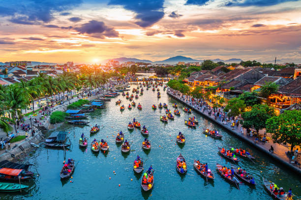 Hoi An river at sunset with lantern boats and Old Town