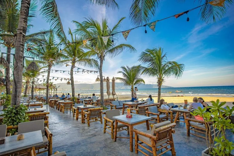 Beachfront restaurant with palm trees beside the ocean in Da Nang