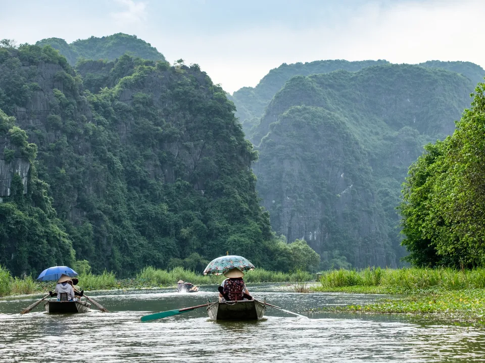 Rowboats beneath limestone karsts in Ninh Binh, northern Vietnam