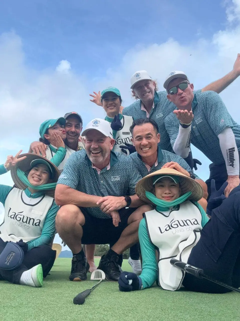 Golfers and caddies together on a Vietnam golf course