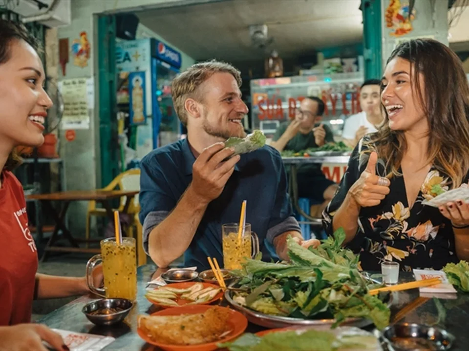 Guests enjoying Vietnamese dishes on a guided Saigon street-food tour