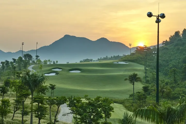 Ba Na Hills Golf Club fairway and mountains in late afternoon light