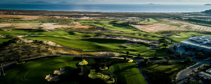 Aerial view across the KN Golf Links Cam Ranh fairways toward the sea