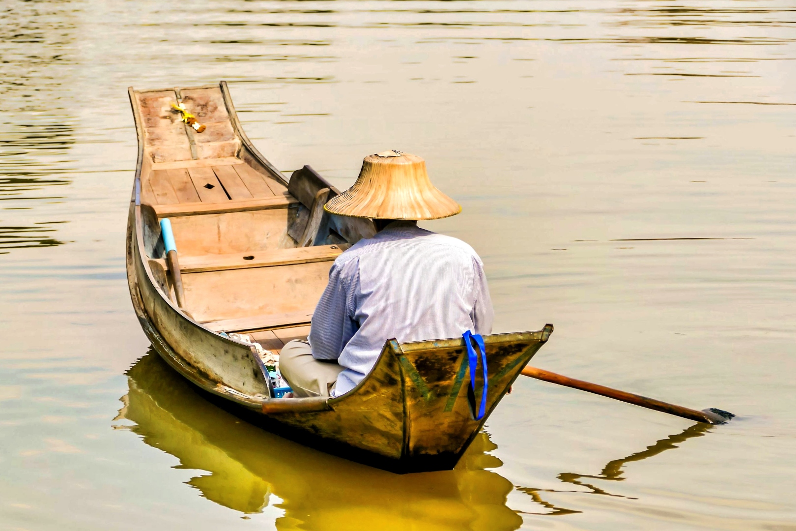 Vietnamese fisherman on traditional wooden boat